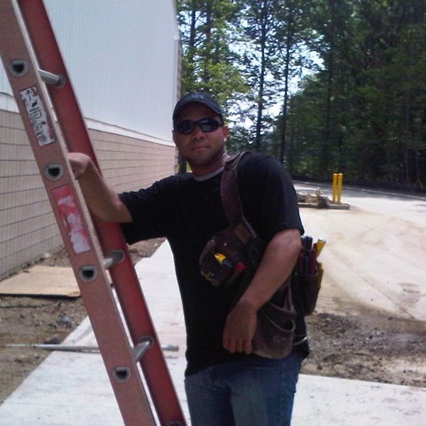 Strongsville electrician working on a ladder