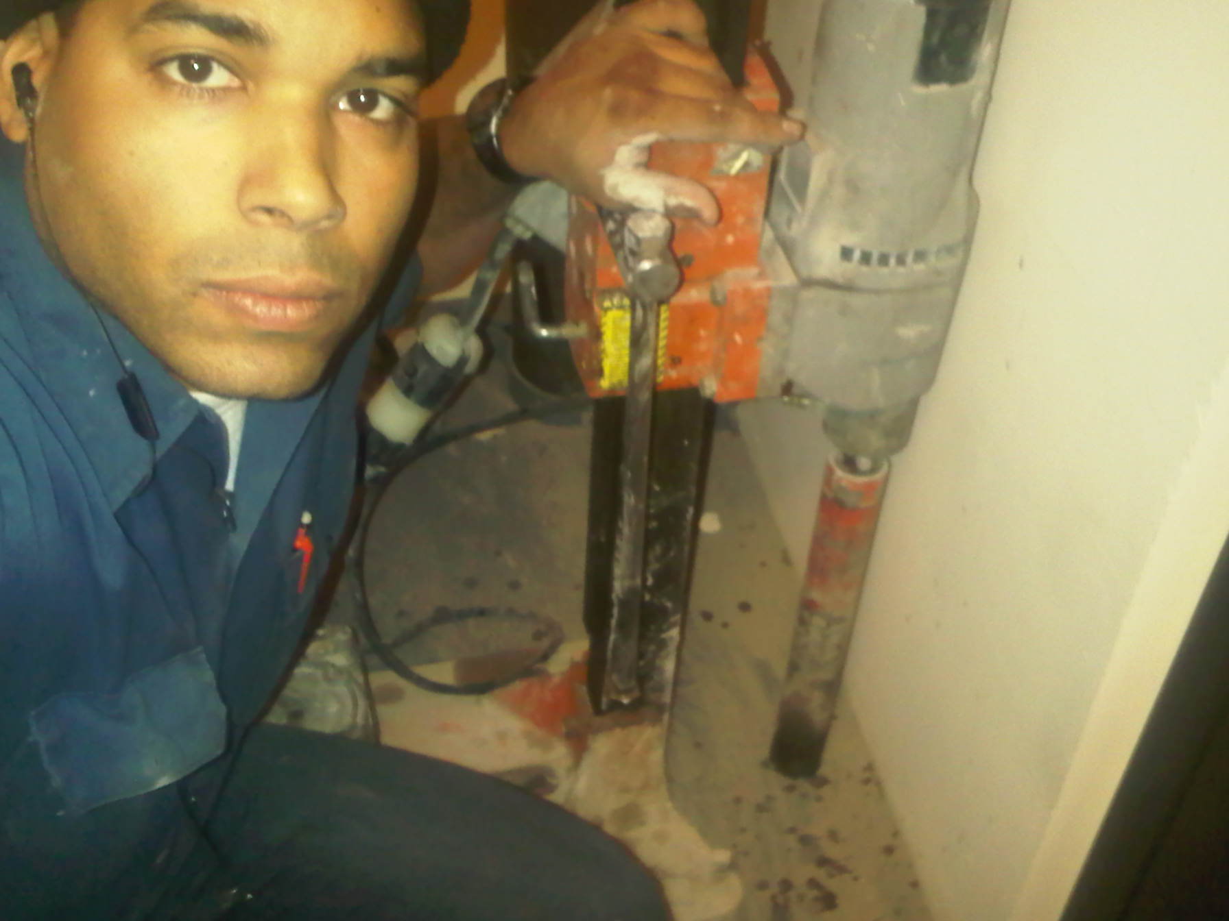 Asmint Cruz, Onwer and Founder of AC Electric Near Cleveland, Ohio Puts Customer Service First Electrical Contractor in Cleveland Asmint Cruz poses near plumbing and electrical fixtures while on the job providing excellent customer service